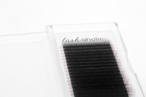False eyelashes in a clear packaging with 'lashaholic' branding on a white background